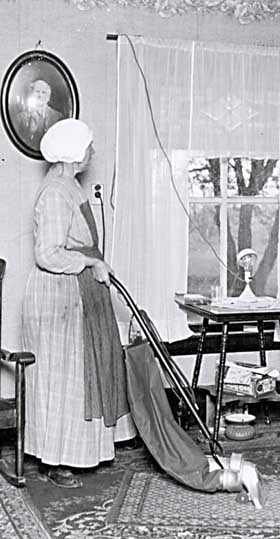 Woman Using Vacuum Cleaner